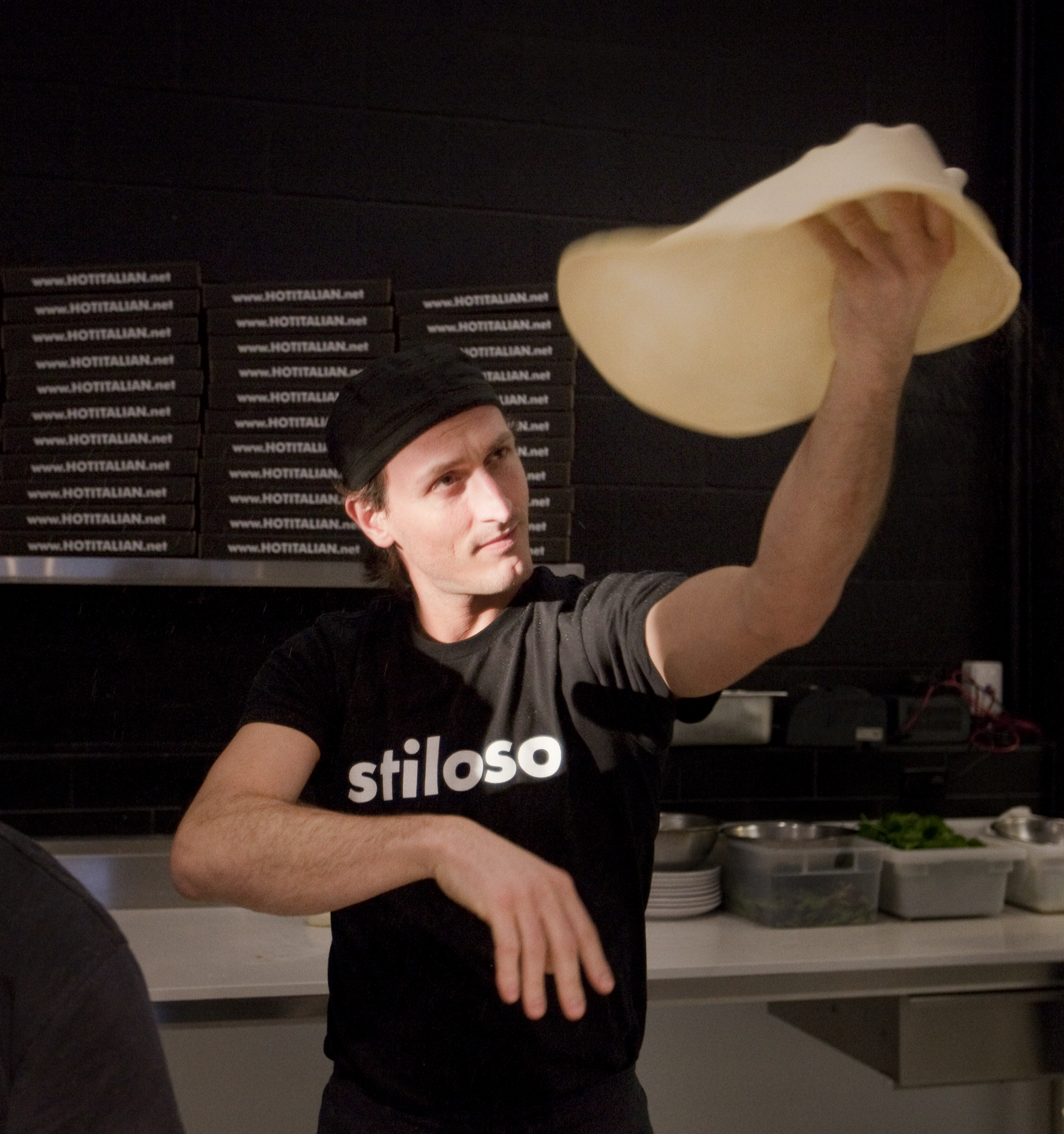 Fabrizio, founder of Passione Emporio, tossing fresh pizza dough